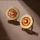 AuraNudge Solar Core gold stud earrings featuring a sunburst design and a central red garnet gemstone.