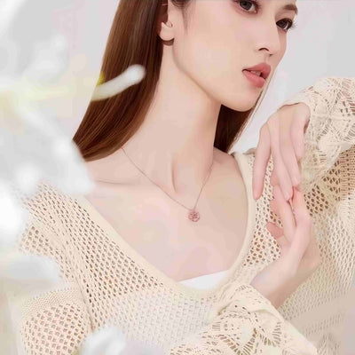 Auranudge Blossom Shift Kinetic Necklace in its unfolded state, revealing four sterling silver hearts.